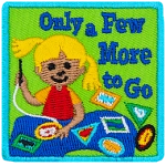 A young girl sews patches onto her sash. The words Only A Few More To Go are next to her.