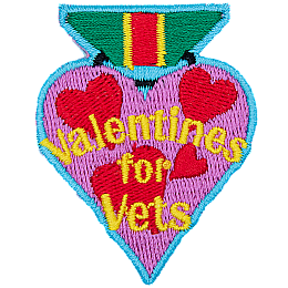 A heart-shaped badge with the words Valentines For Vets in the center.