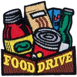 The words Food Drive are on a box holding nonperishables.