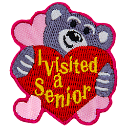 A teddy bear hugs a heart that says I Visited A Senior.