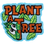 The words Plant A Tree are sewn in brown thread. Green leaves grow from them. One leaf has a curious face.