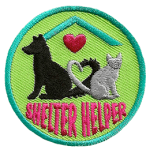 A cat and dog sit facing away from each other. Their tails curve together to make a heart. The words Shelter Helper are at the bottom.