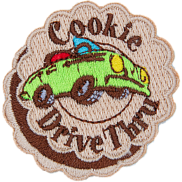 A green convertible car with the words Cookie Drive Thru stitched on a patch made to look like a layered cookie.