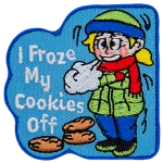A young girl is bundled up in a hat, scarf, jacket, and thick pants as she stands shivering in the cold. Three cookies lie under the text I Froze My Cookies Off.