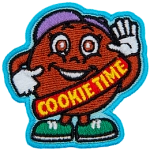 A large cookie dressed in a guide's uniform gives a thumbs up. The words Cookie time are stitched across her sash.