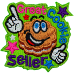 A flower-shaped cookie with frosting in the middle and big, cartoon eyes grins and points to the words Great Cookie Seller.