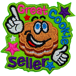 A flower-shaped cookie with frosting in the middle and big, cartoon eyes grins and points to the words Great Cookie Seller.