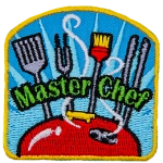 A spatula, fork, brush, and a set of tongs stand proudly over a steaming barbecue lid. The words ''Master Chef'' are embroidered over top of the utensils. 