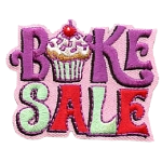 The words Bake Sale with a cupcake as the A.