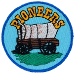 An old covered wagon sits under a heading that reads Pioneers.