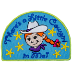 The words There's A Little Cowgirl In Me are above and below a little girl with braided red hair and a white cowboy hat.