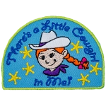 The words There's A Little Cowgirl In Me are above and below a little girl with braided red hair and a white cowboy hat.