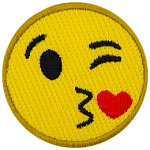 A yellow circle forms a smiley face with one eye closed in a wink, kissy lips, and a red heart.