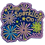 The words Keep Sparkling On are surrounded by pink, gold and blue fireworks.