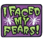 The words I Faced My Fears are in drippy green text with two white spiders on either side.