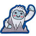 This happy yeti waves a warm welcome as they hold onto the Himalayan Mountains.