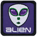 A classic alien head with big eyes and white skin on a purple background. The word Alien is below the head.