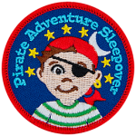 A young boy with an eyepatch and a red bandana. The words Pirate Adventure Sleepover are in an arc above his head.