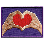 Two hands form a red heart on a purple background. The left hand is brown, and the right is beige.