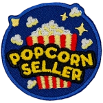 A bucket of popcorn with the words Popcorn Seller on the front.