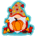 A gnome holds a ripe pumpkin. The gnome is covered in leaves and wears a red and yellow polka-dotted hat.