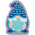 A gnome wearing a blue toque holding a snowflake.