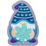 A gnome wearing a blue toque holding a snowflake.