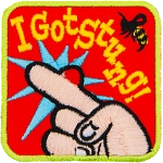 A hand holds out its pointer finger with a bug bite on it. The words I got Stung are in an arc around it, and an insect is in the far right corner.