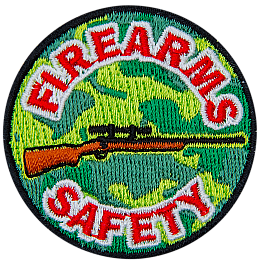This light and dark green camouflage patch depicts a rifle with the words Firearms Safety embroidered in red and white.