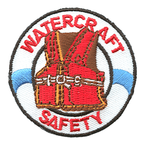 A red lifejacket sits inside a white life preserver. The words Watercraft Safety are stitched around the inside of the preserver. 