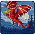 A red dragon blows fire midflight with a castle in the background.