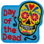 The words Day Of The Dead are next to a Calaveras.
