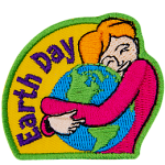 A woman is shown hugging the Earth. The words Earth Day are across the left.