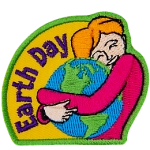 A woman is shown hugging the Earth. The words Earth Day are across the left.