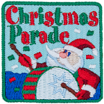 The words Christmas Parade are above a Santa Claus banging a drum.