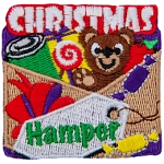 The words Christmas Hamper surround a basket full of toys and candy.