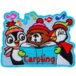 A penguin, a puffin and a beaver sing from a book in front of them. The word Caroling is at the bottom.