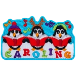 Three penguins dressed in different hats sing carols with Caroling stitched below them.