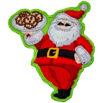 Santa Clause proudly holds up a tray of cookies and gives a big jolly smile.