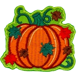 Green, red, and brown leaves rain down on a plump pumpkin still attached to the vine.