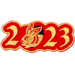 Golden numbers form 2023 on a background of red twill. A golden rabbit is shown peeking out of the 0.