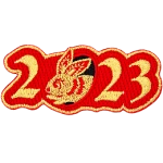 Golden numbers form 2023 on a background of red twill. A golden rabbit is shown peeking out of the 0.