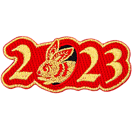 Golden numbers form 2023 on a background of red twill. A golden rabbit is shown peeking out of the 0.