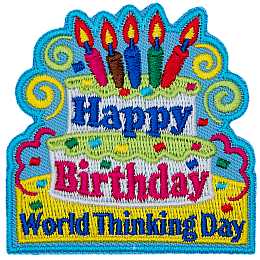 A two-tiered birthday cake with candles and the words Happy Birthday on it. Below the cake are the words World Thinking Day.
