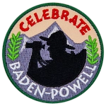 The words Celebrate Baden-Powell are around a silhouette of an explorer and a mountain range.