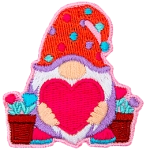 A gnome holds a big heart, and potted heart flowers stand to either side of him.