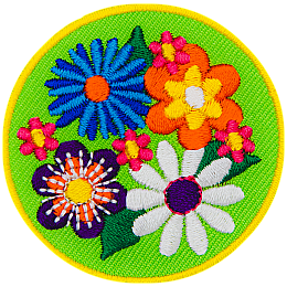 Four large flowers (a blue, an orange, a purple and a white one) are on a green background with tiny pink flowers in between them.