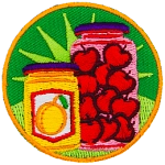 A jar of marmalade next to a jar of cherries.