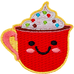 A red mug of cocoa is topped with whipped cream and sprinkles. The mug has dots for eyes and a big U-shaped smile.