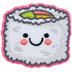 A piece of rice-coated sushi has a center of green, pink, and yellow. The sushi has a kawaii face.